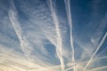 Pattern of several aircraft contrails in the sunset sky