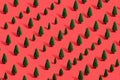 Pattern of miniature-pine trees on a red-background. Royalty Free Stock Photo