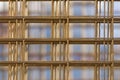 Pattern from stack of rebar grids on blue background