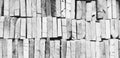 Pattern stacked of gray wood lumber, log or timber for background in black and white style