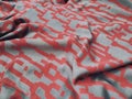 The pattern, texture, and background of the fabric are gray with red geometric patterns Royalty Free Stock Photo