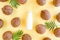 Pattern, texture with coconuts and coconut milk, cocktail on yellow background. Tropical abstract background. Flat lay Royalty Free Stock Photo