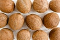 Pattern, texture with coconuts on white background. Tropical abstract background. Flat lay, top view. Royalty Free Stock Photo