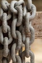 Pattern of thick rusty chain hang on wooden rail