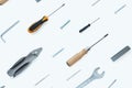 A pattern of tools: nippers, screwdrivers, bolts, staples for a stapler, self-tapping screws, nut on a white background Royalty Free Stock Photo