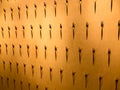 The pattern of a variety of metal forks, cutlery on the wall on a yellow background. Texture