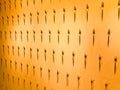 The pattern of a variety of metal forks, cutlery on the wall on a yellow background. Texture