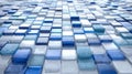 Pattern of various blue and white textured glass tiles arranged in a geometric grid with a glossy finish and subtle reflections on Royalty Free Stock Photo