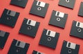 Pattern of vintage magnetic floppy disks arranged on a red surface. Old computer data storage media objects create a retro tech Royalty Free Stock Photo