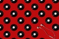 Pattern of vinyl records and earphones on a red background. Minimal trendy composition Royalty Free Stock Photo
