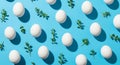 Pattern of White Easter Eggs and Green Twigs on a Vibrant Blue Background image photo Royalty Free Stock Photo