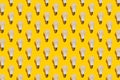 Pattern of white energy saving light bulbs on a yellow background Royalty Free Stock Photo