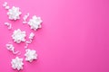Pattern white flowers on pastel pink background. Flat lay, top view. Celebration concept