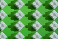 Pattern of white plastic blocks of a children`s constructor on a green background. Child development concept, logic, thinking and Royalty Free Stock Photo