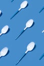 Pattern of white spoons on blue background. Royalty Free Stock Photo