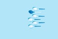 Pattern of white spoons on blue background. Royalty Free Stock Photo