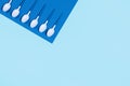 Pattern of white spoons on blue background. Royalty Free Stock Photo