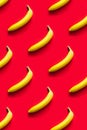 Pattern of yellow bananas on a red background. Royalty Free Stock Photo