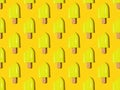 A pattern of yellow bitten popsicles on a yellow background