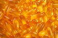 pattern with yellow gelatin capsules for background. omega viramins close-up macro