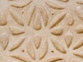 Patterned beige wall with floral geometric motif. Elegant ornate in sgraffito technique on building outside in Segovia, Spain.