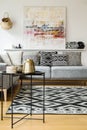 Patterned carpet and cushions on grey sofa in modern living room