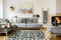 Patterned carpet in decorative living room interior with painting above couch. Real photo Royalty Free Stock Photo