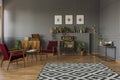 Patterned carpet in grey living room interior with dark red wood