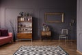 Patterned carpet in spacious grey retro living room interior wit