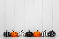 Patterned Halloween pumpkins in a row against a white wood background Royalty Free Stock Photo