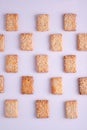 patterned mosaic of cookies with sesame seeds on a white background