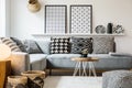 Patterned pillows on grey corner sofa in apartment