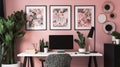 Patterned poster on table with computer monitor in Pink home office interior with plants Royalty Free Stock Photo