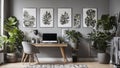 Patterned posters above desk with computer monitor in grey home office interior with plants Royalty Free Stock Photo