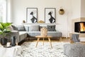 Patterned pouf next to wooden table in african living room inter