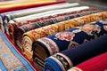 patterned prayer mats arranged neatly for a religious event