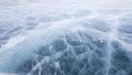 Patterns of cracks on the ice of the frozen lake Baikal. A winter journey through Russia