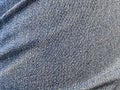 Patterns of faded blue jeans that are wrinkled and have color gradation. Fabric Textile Drape with Crease Wavy Folds. Royalty Free Stock Photo