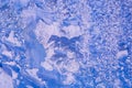 patterns on glass, frosty drawings in winter on window, blue background and ice drawings, droplets of fody, reflection through