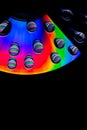 Patterns of light and color created by water drops refracting light/abstract background with rainbow colors and copy space Royalty Free Stock Photo