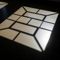 Patterns of light and shadow are cast on a dark surface with a grid Royalty Free Stock Photo