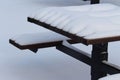 Patterns and lines in snow on a picnic table