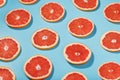 Patterns of slices of juicy Grapefruit on a blue background, a beautiful pattern Royalty Free Stock Photo