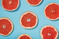 Patterns of slices of juicy Grapefruit on a blue background, a beautiful pattern Royalty Free Stock Photo