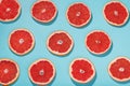 Patterns of slices of juicy Grapefruit on a blue background, a beautiful pattern Royalty Free Stock Photo