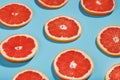 Patterns of slices of juicy Grapefruit on a blue background, a beautiful pattern Royalty Free Stock Photo