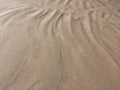 Patterns from the waves and wind on the sand, sand of an unusual color