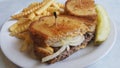 Patty melt with french fries and a dill pickle Royalty Free Stock Photo