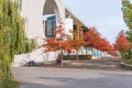 Paul Loebe Allee lined with autumn coloured trees and buildings of the German Federal Chancellery in Berlin, Germany Royalty Free Stock Photo