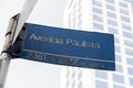 Paulista Avenue sign with mirrored buildings in the background during the day. Royalty Free Stock Photo